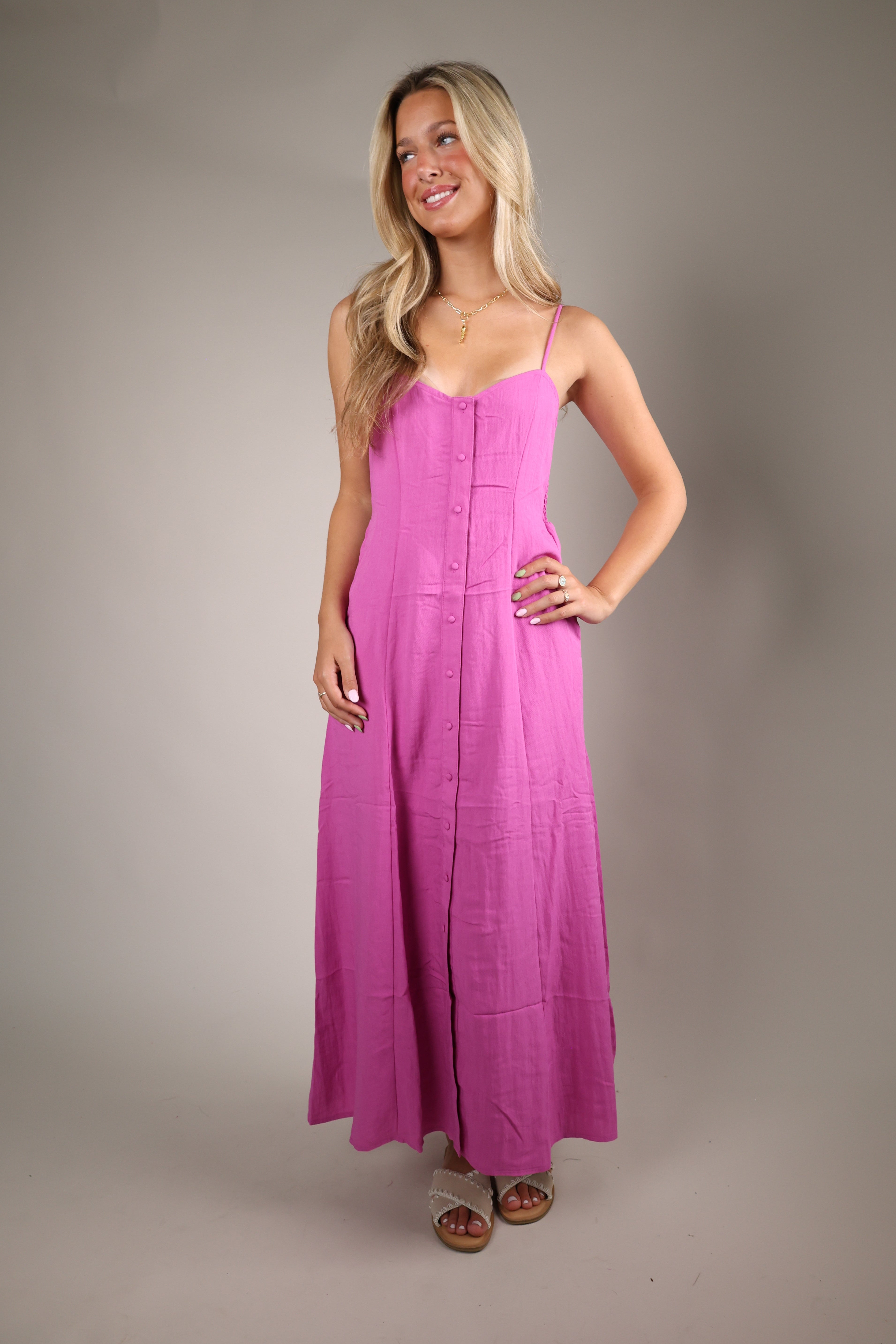 Chic blush pink midi dress with a soft romantic shape perfect for weddings vacations and elevated summer occasions