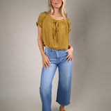 Women’s lightweight chiffon blouse with a scoop neckline, keyhole detail, and romantic puff sleeve design for summer styling
