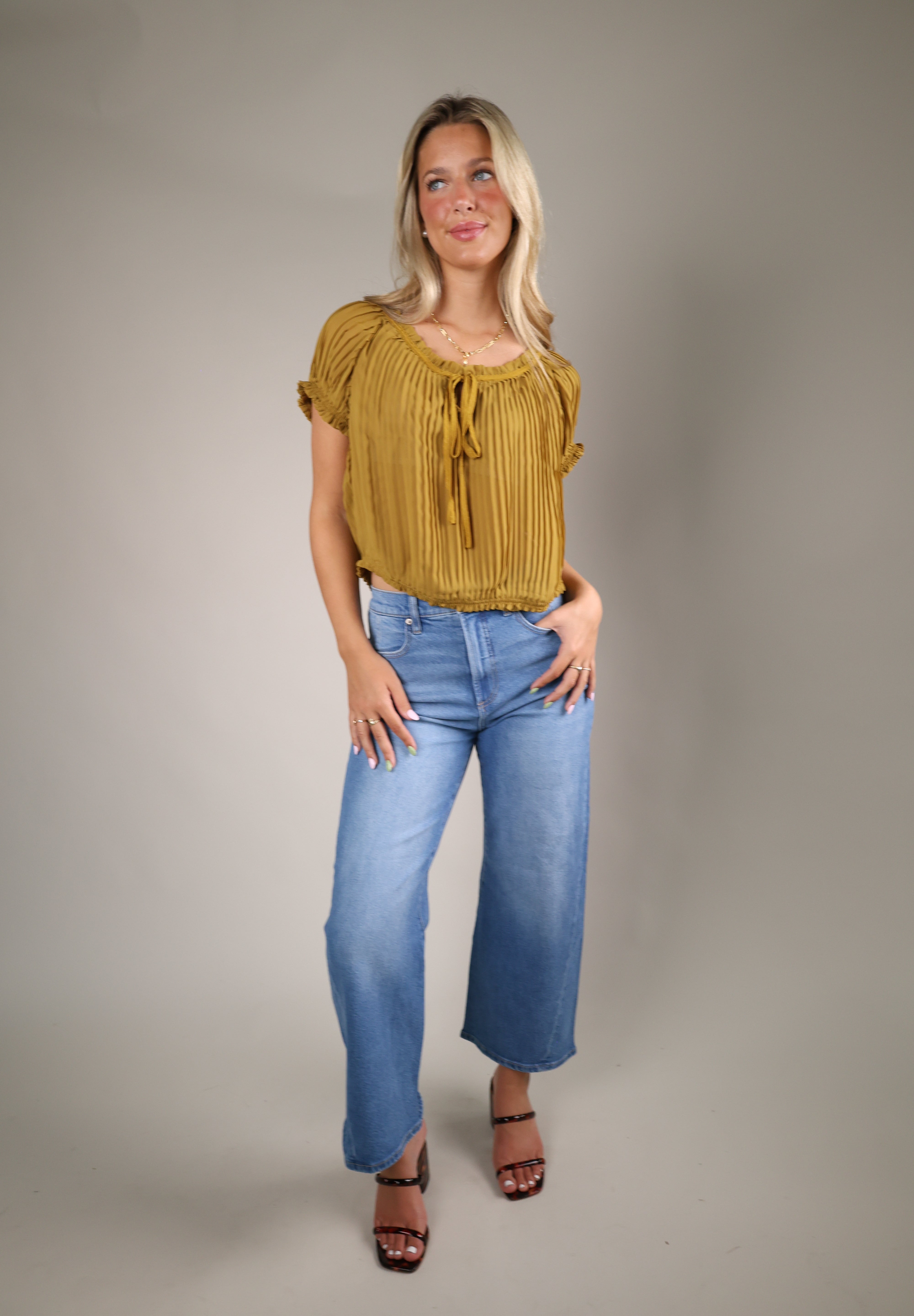 Women’s lightweight chiffon blouse with a scoop neckline, keyhole detail, and romantic puff sleeve design for summer styling