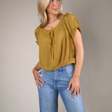 Yellow pleated chiffon top featuring delicate ruffle accents, relaxed fit, and elevated feminine boutique style