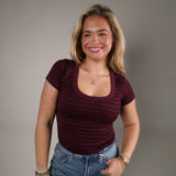 Striped seamless scoop neck top styled with denim for an effortless everyday outfit