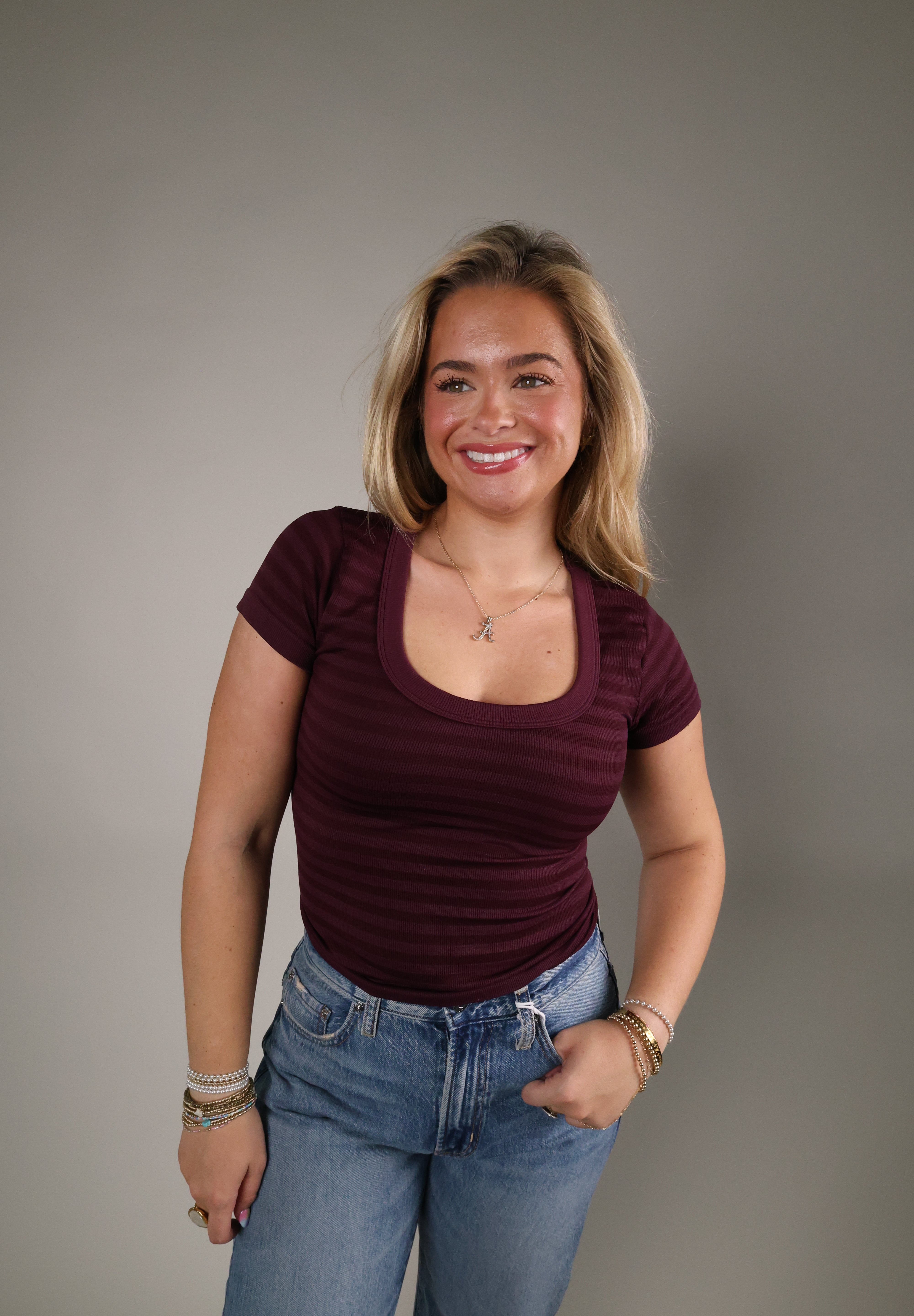Striped seamless scoop neck top styled with denim for an effortless everyday outfit