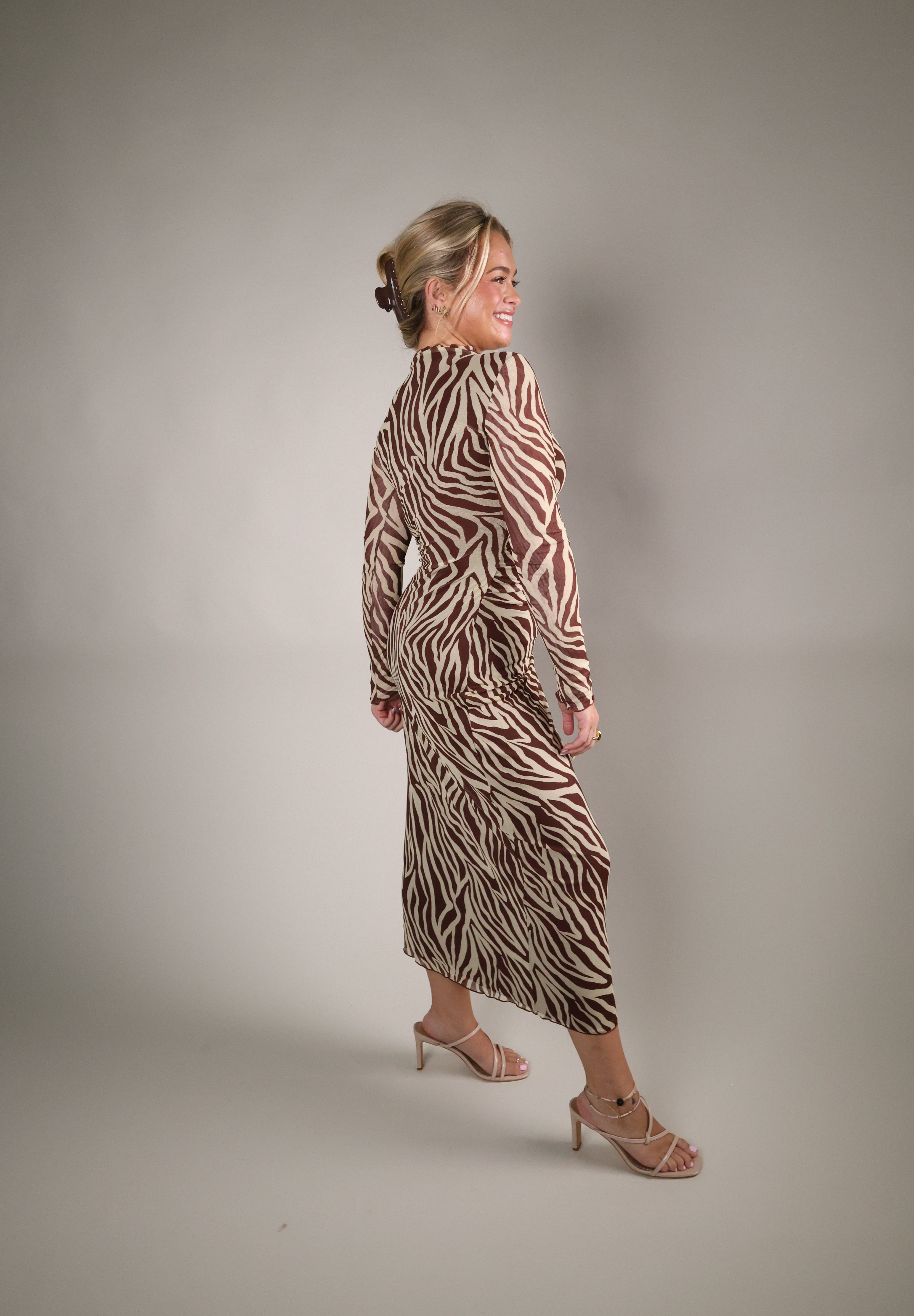 Sevilla zebra mesh midi dress styled with heels for an elegant dinner or date night outfit