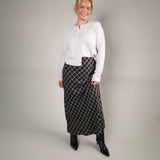 Women’s black plaid maxi skirt with a comfortable elastic waistband and soft flannel-like fabric.
