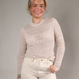 Women’s fitted knit sweater top with long sleeves, mock neckline, and intricate textured knit